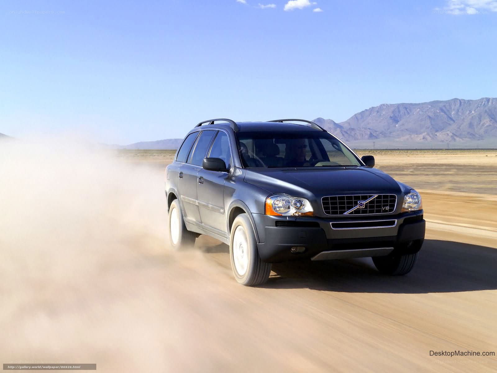 Volvo SUV driving on desert road