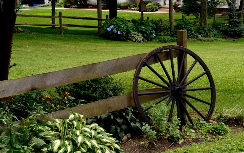 Wagon Wheel by Fence