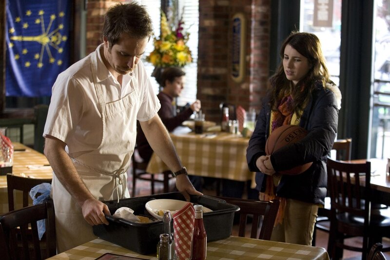 Waiter and woman in a restaurant