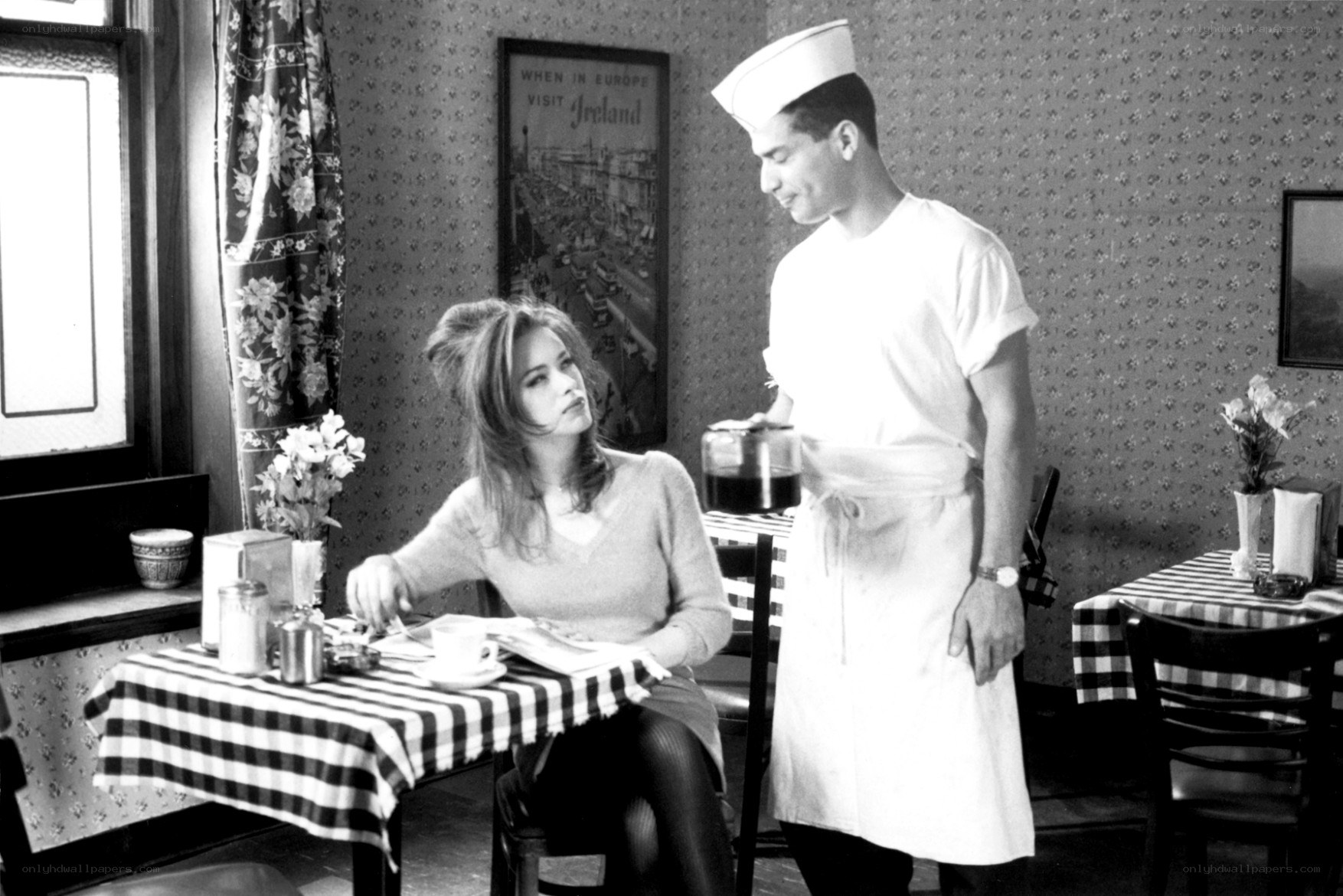 Waiter serving coffee in diner