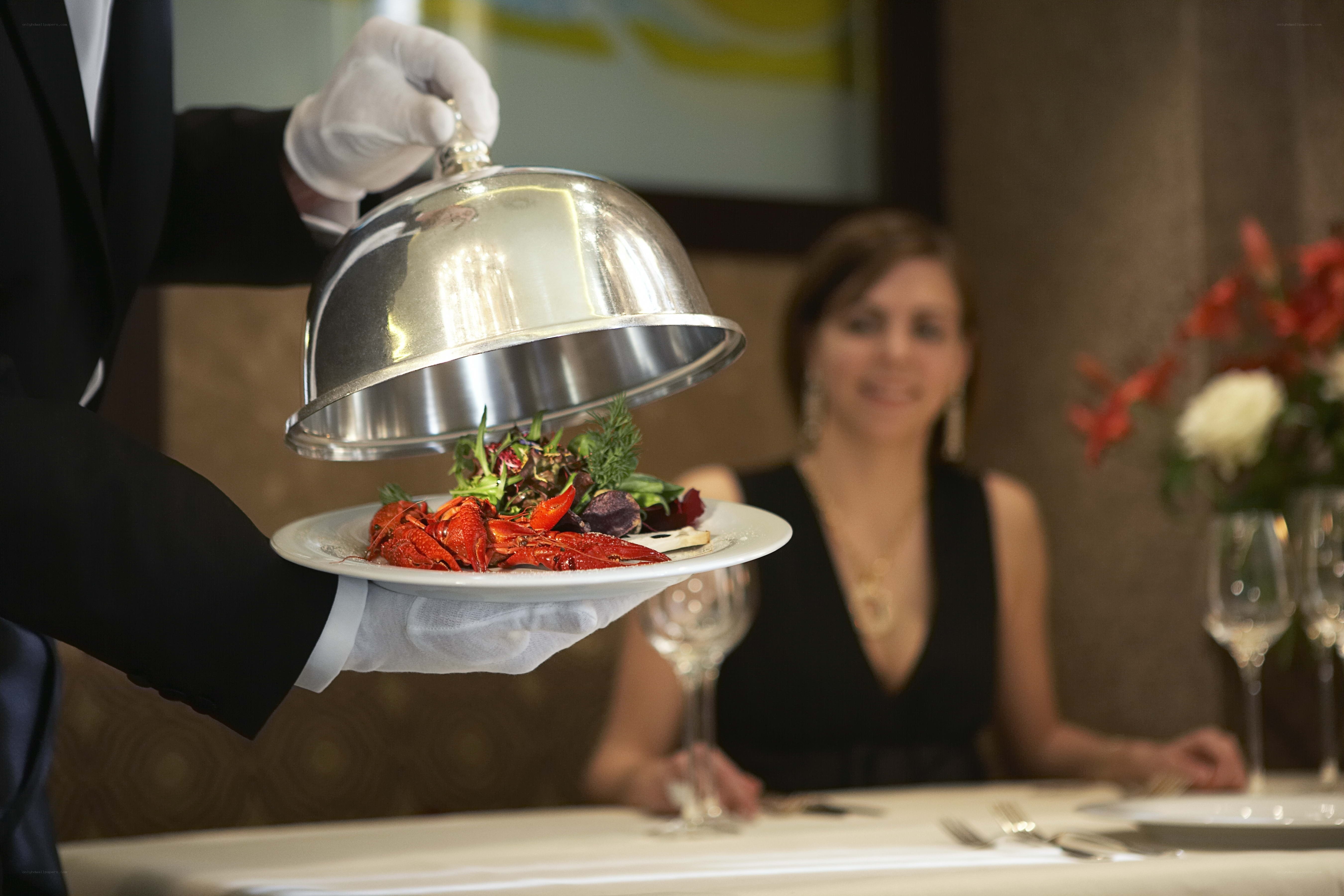 Waiter serving seafood dish