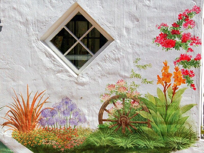 Wall mural with flowers and wheel