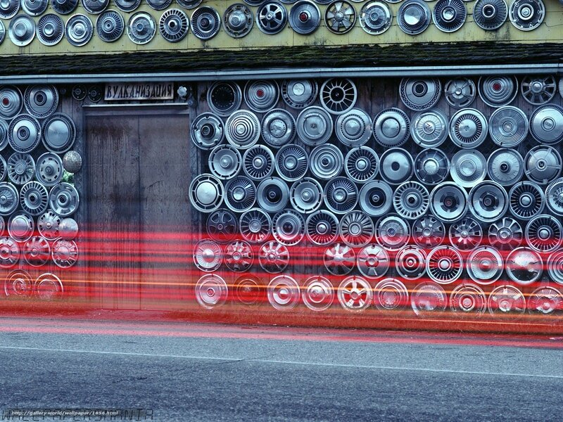 Wall of hubcaps with light trails