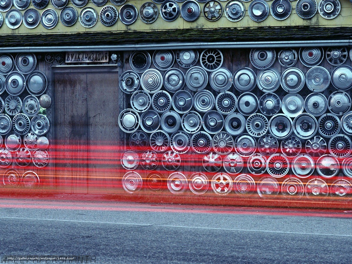 Wall of hubcaps with light trails