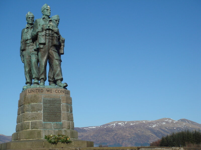 War memorial statue with mountains