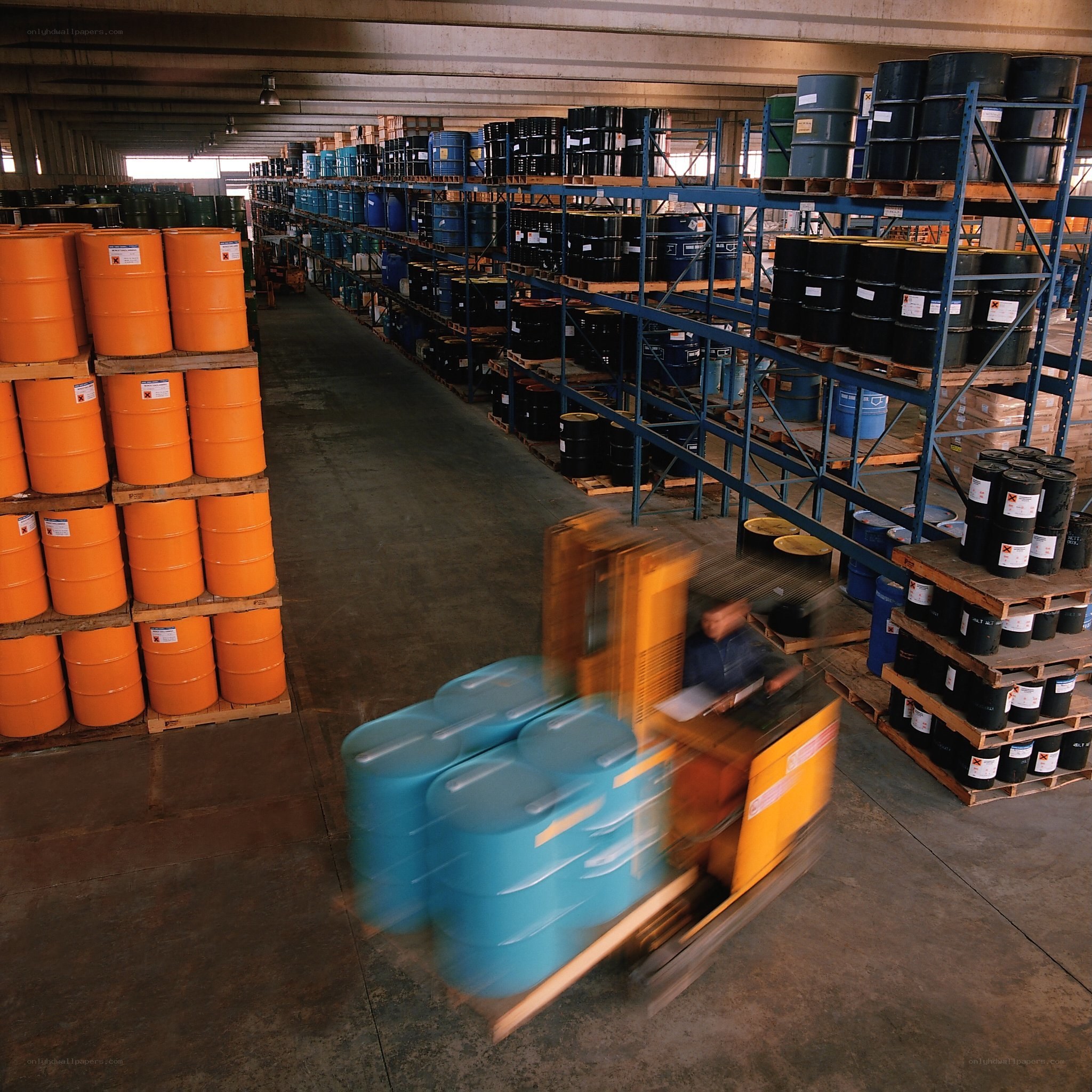 Warehouse with barrels and forklift