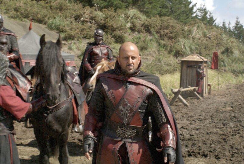 Warrior in red armor on a muddy field