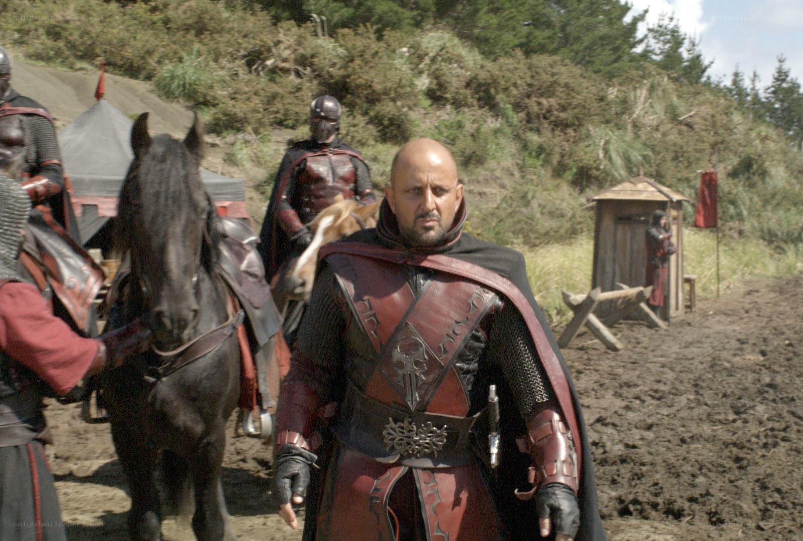 Warrior in red armor on a muddy field
