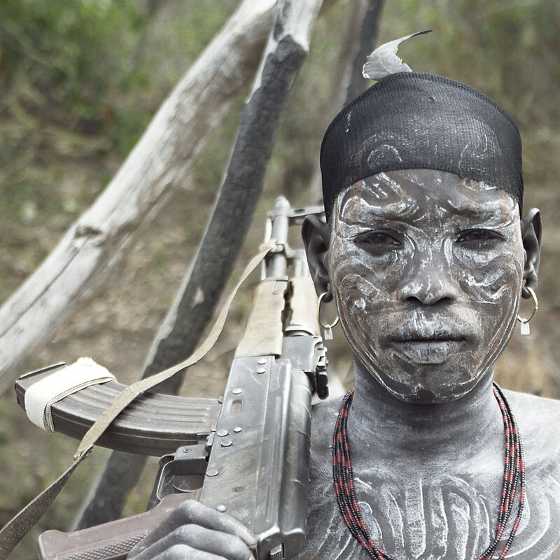 Warrior with rifle and face paint