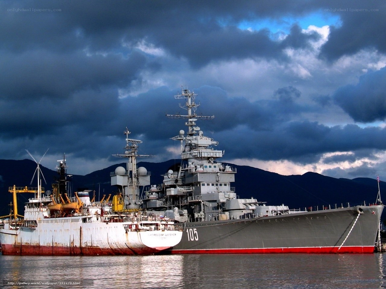 Warship in harbor under stormy sky