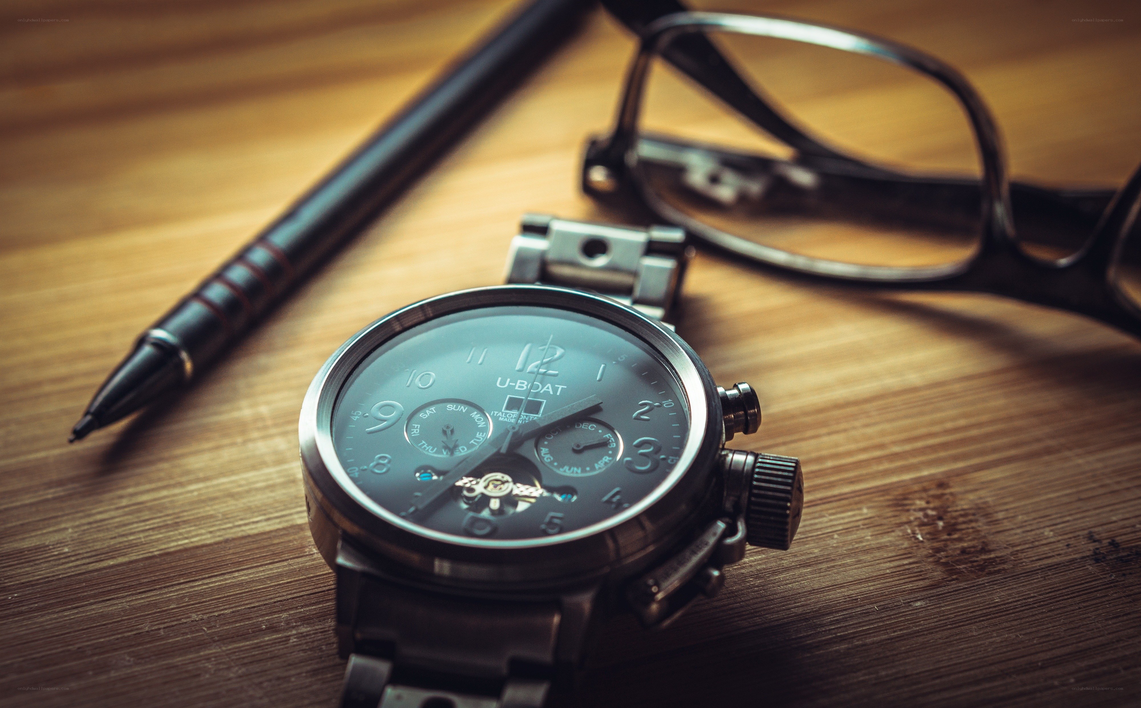 watch with pen and glasses