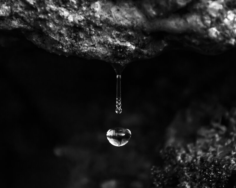 Water drop falling from rock