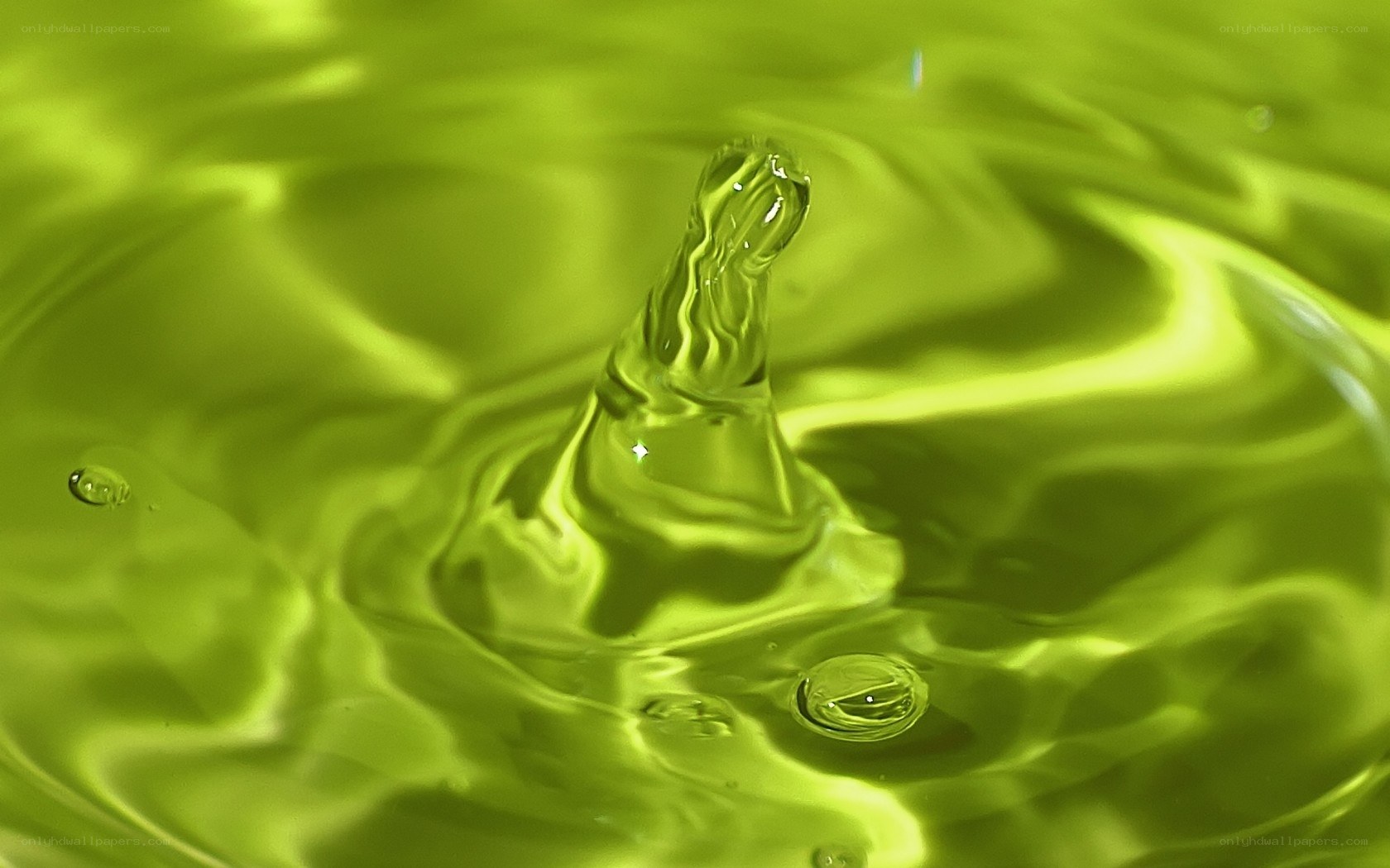 Water drop impact in green liquid