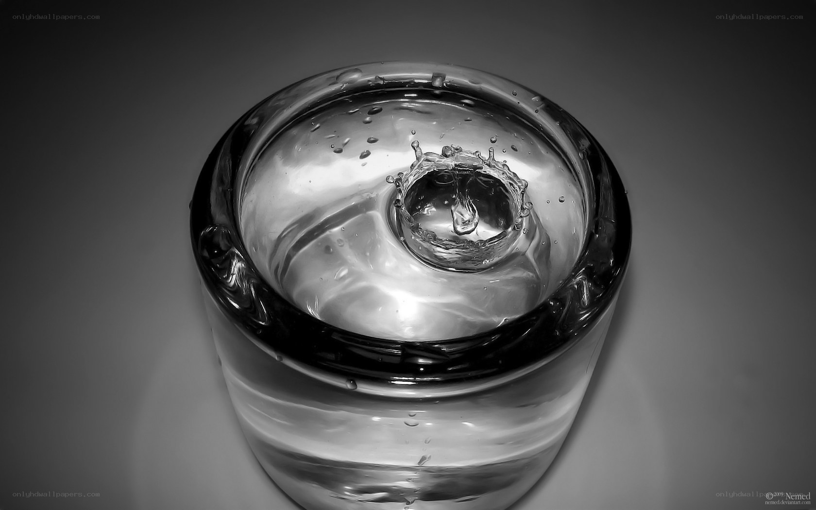Water drop splash in glass