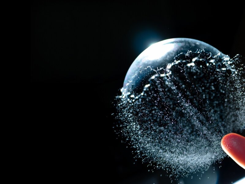 Water droplet bursting on finger