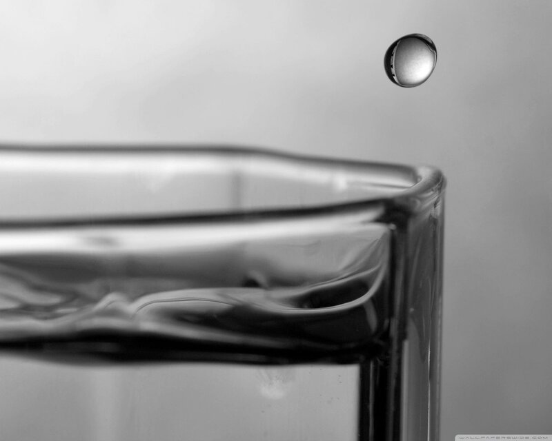 Water droplet falling into glass