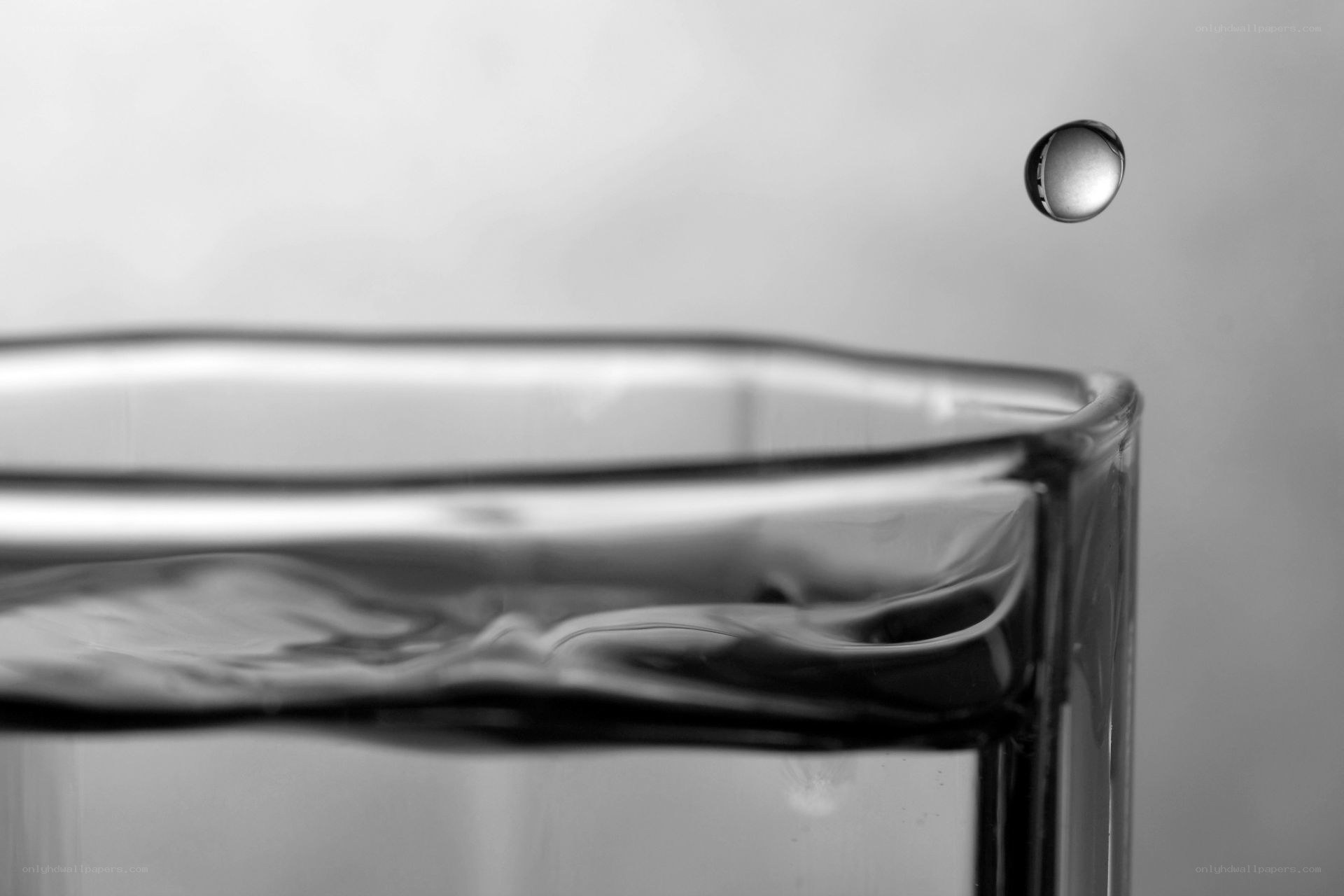 Water droplet falling into glass