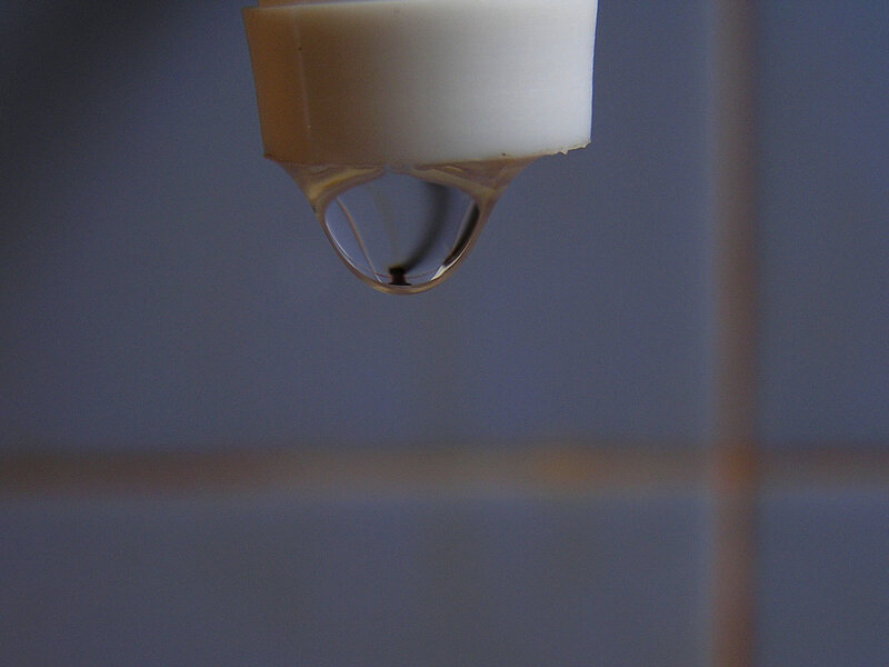 Water droplet forming on faucet