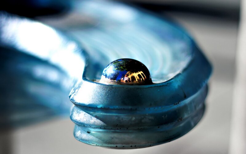 Water droplet on blue glass