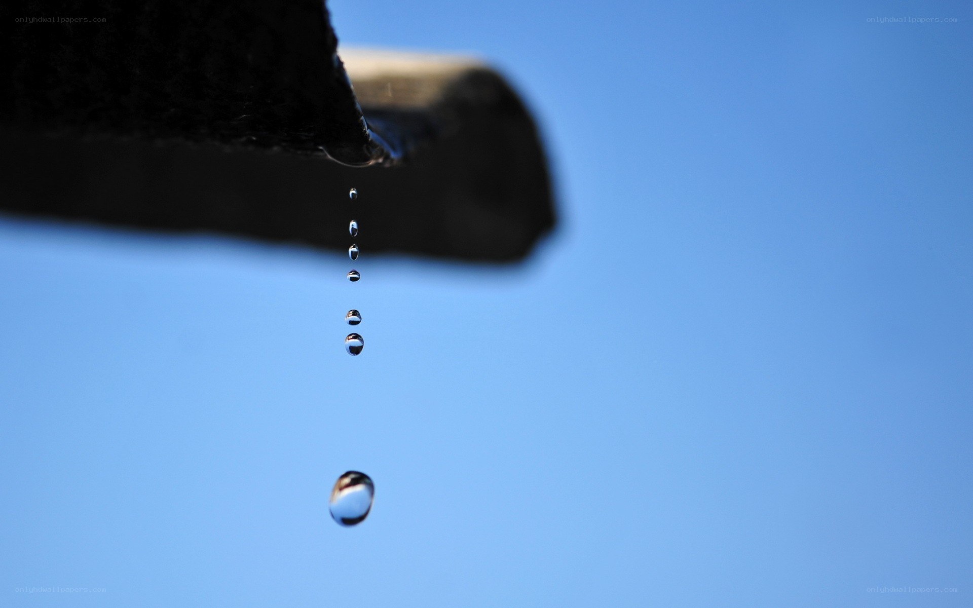 Water droplets falling from a roof