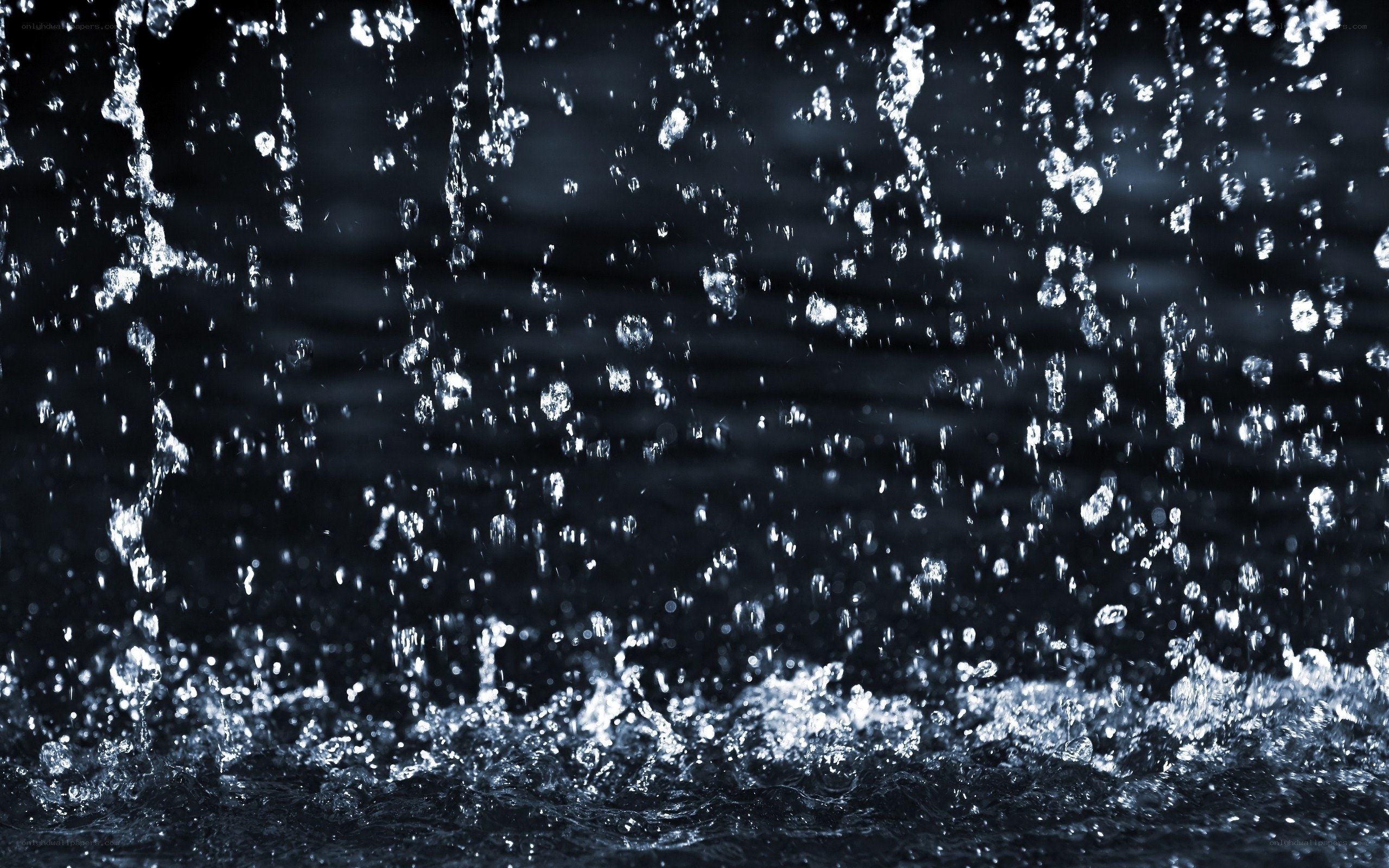 Water droplets falling in dark