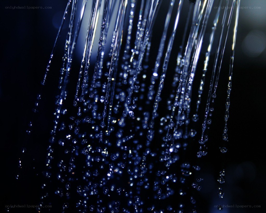 Water droplets falling in dark