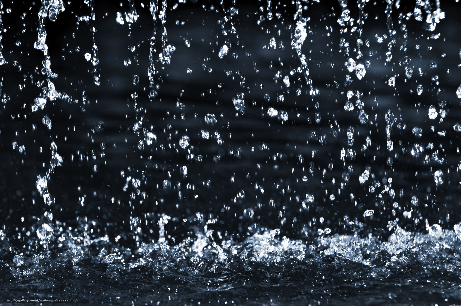 Water droplets falling in dark