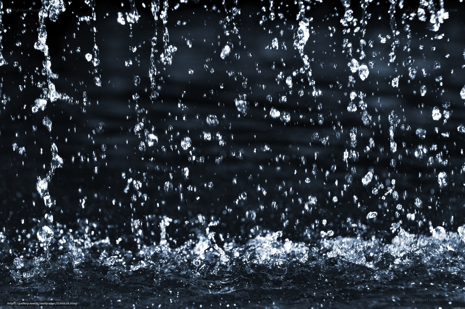 Water droplets falling in dark