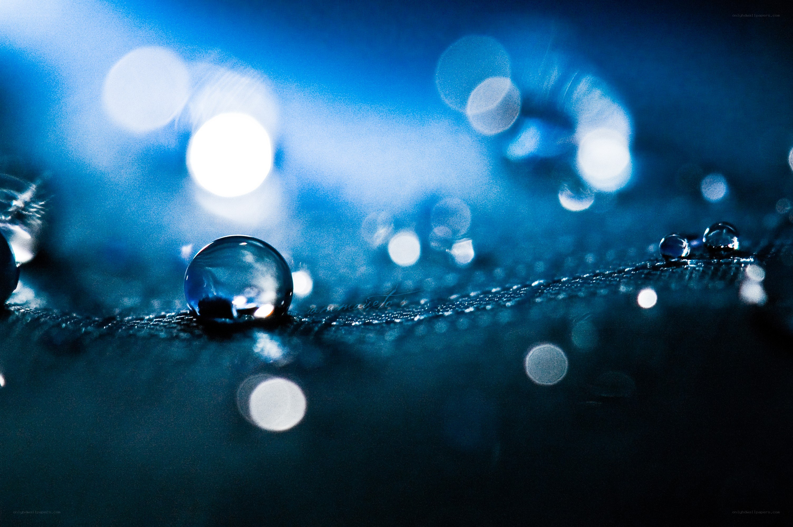 Water droplets on a blue surface