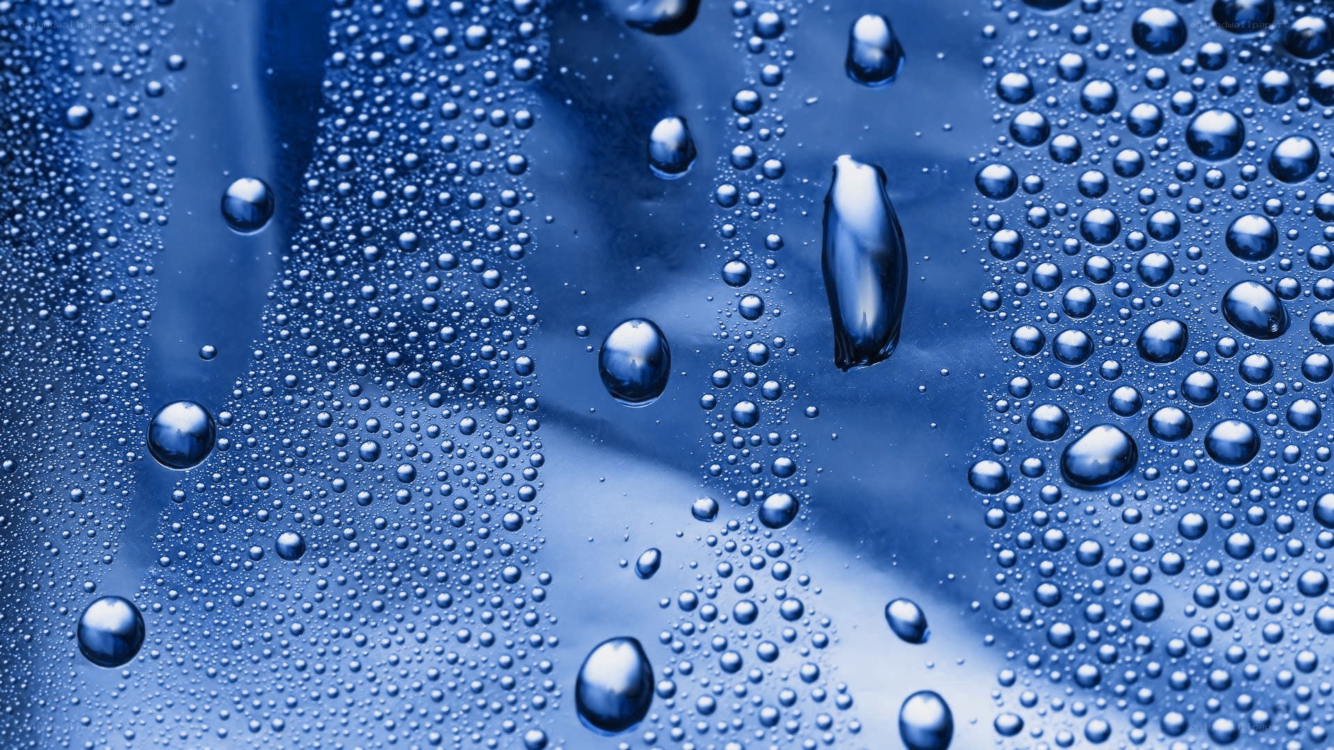 Water droplets on a blue surface