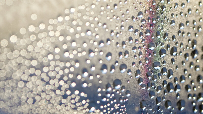 Water droplets on a reflective surface