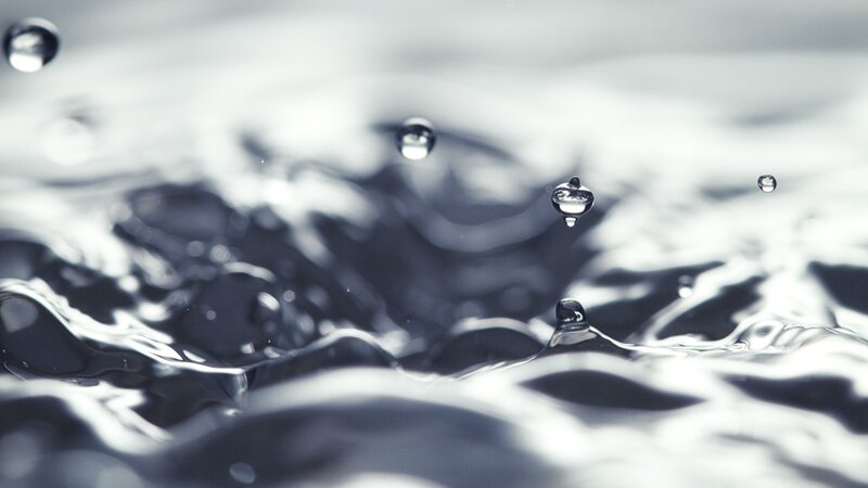 Water droplets on a rippling surface
