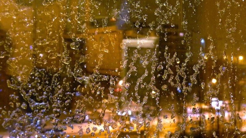 Water droplets on a window at night