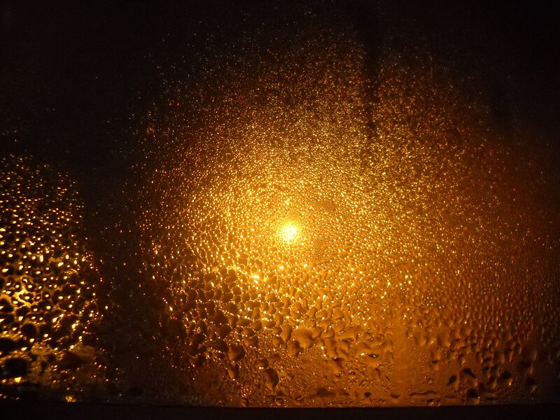 Water droplets on a window at night