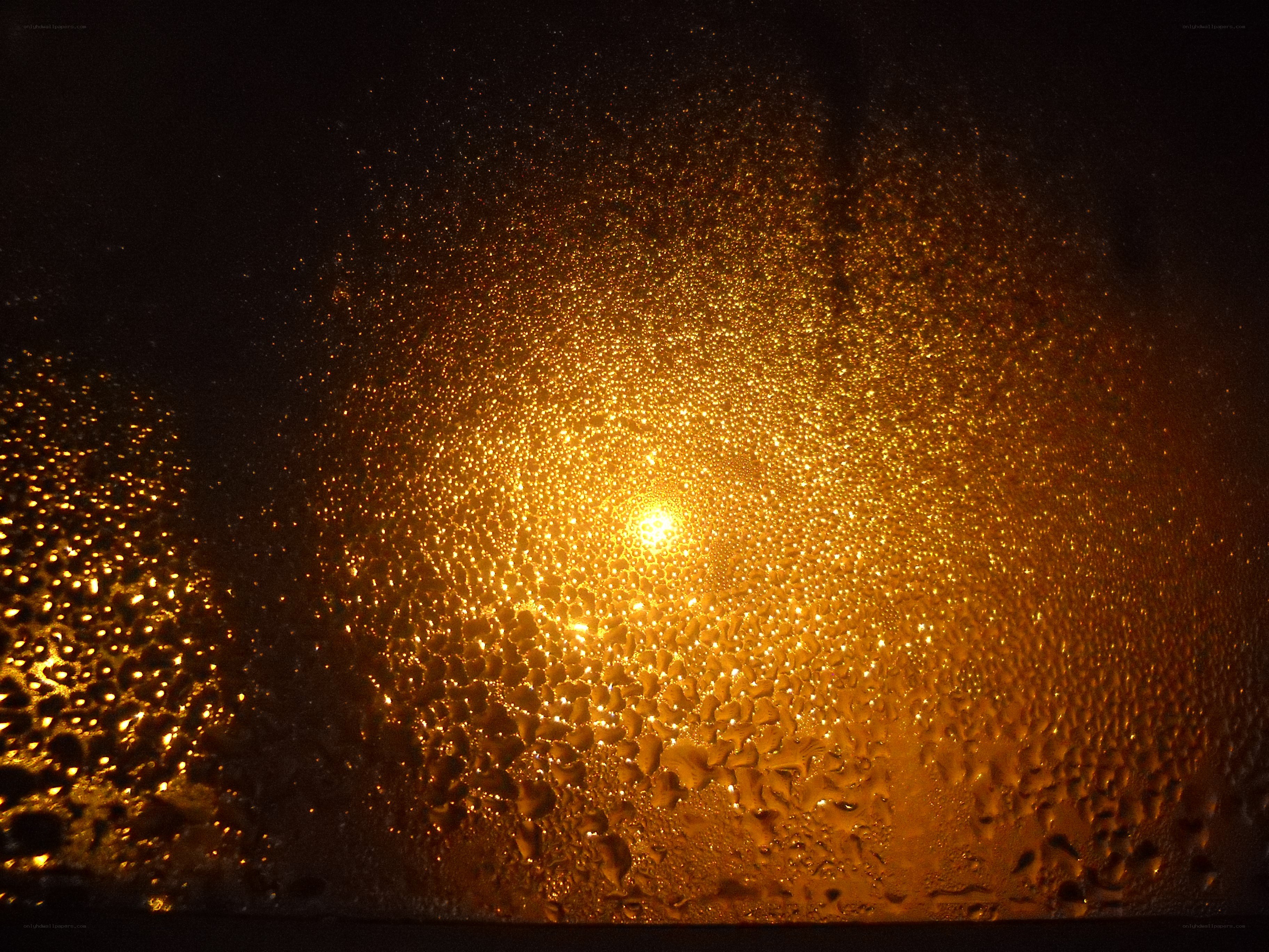 Water droplets on a window at night