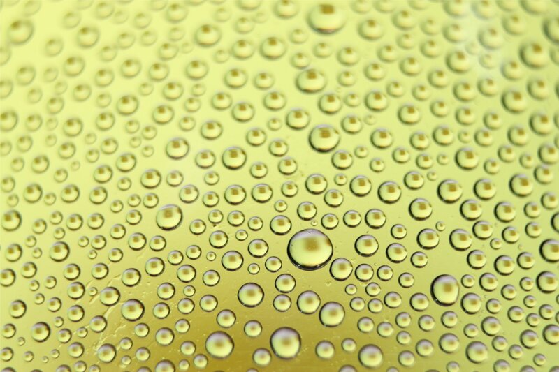 Water droplets on a yellow surface