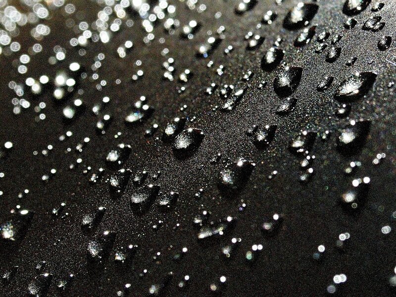 Water Droplets on Black Surface — Dramatic, Photograph
