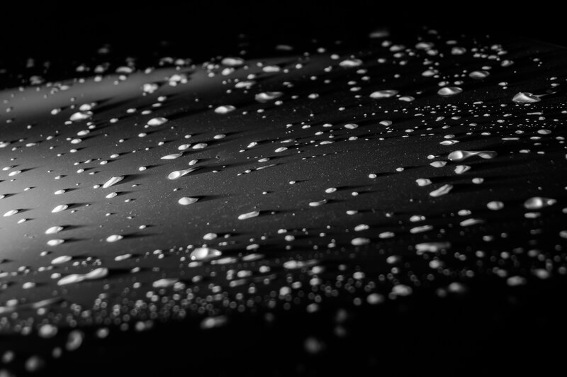 Water Droplets on Black Surface — Dramatic
