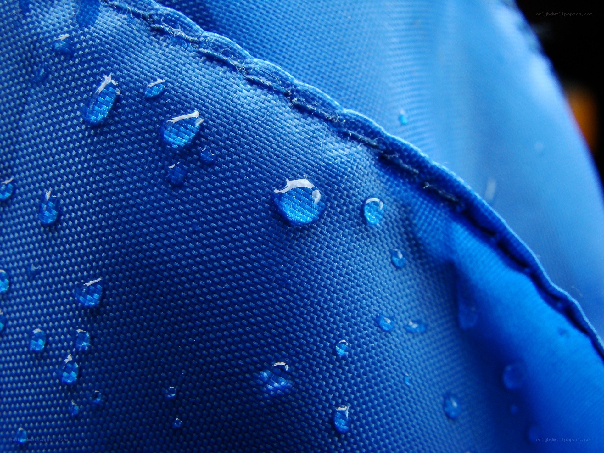 Water droplets on blue fabric