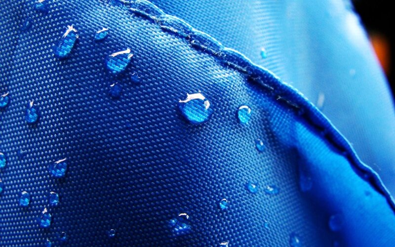 Water droplets on blue fabric