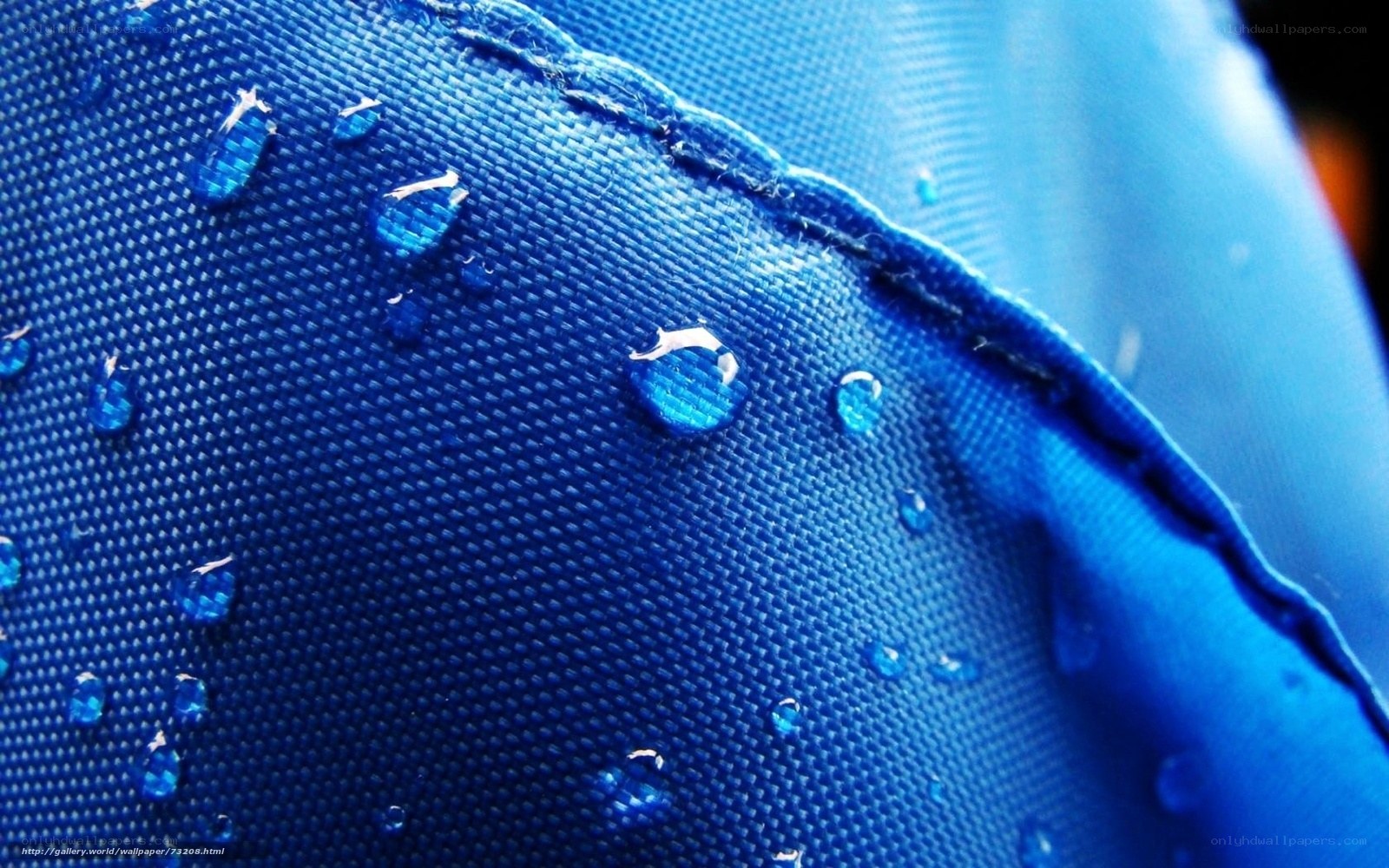 Water droplets on blue fabric