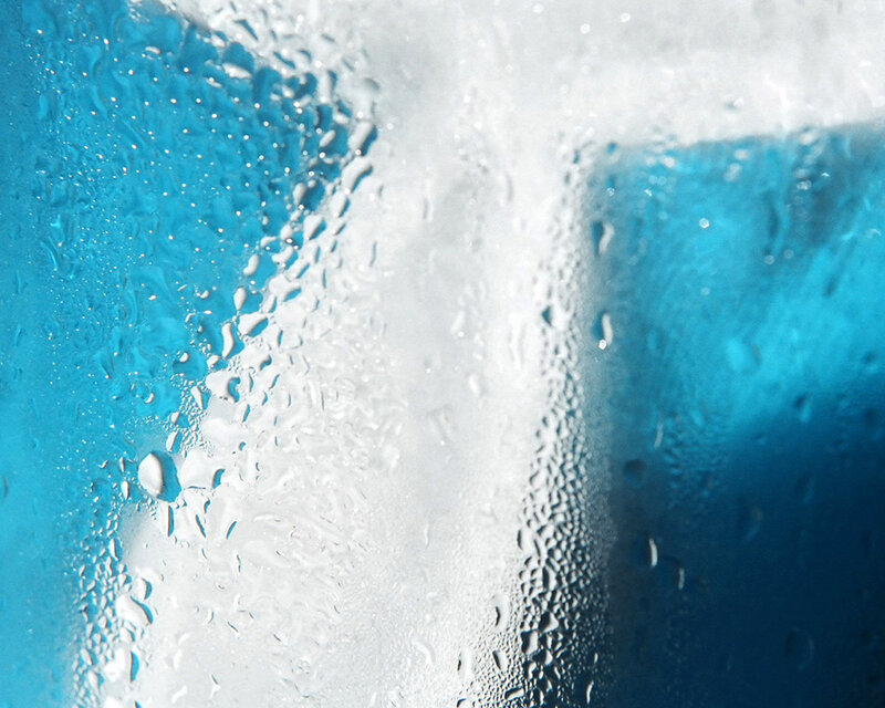 Water droplets on blue glass