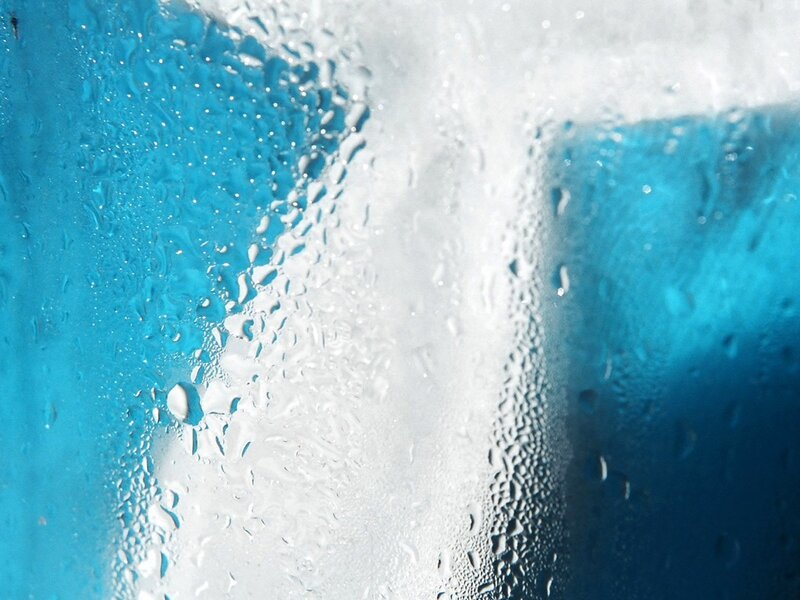 Water droplets on blue glass
