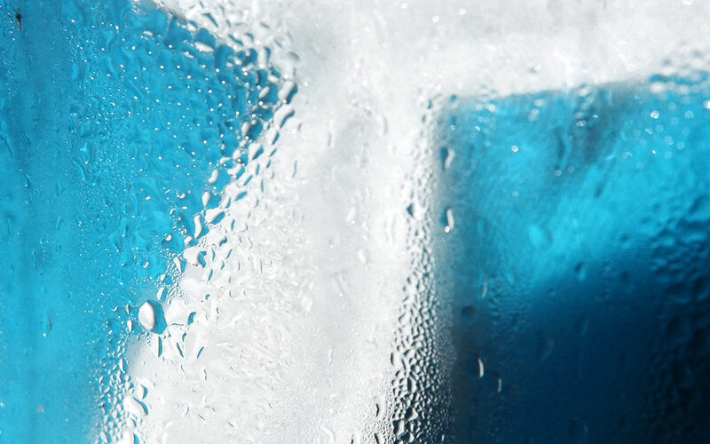 Water droplets on blue glass