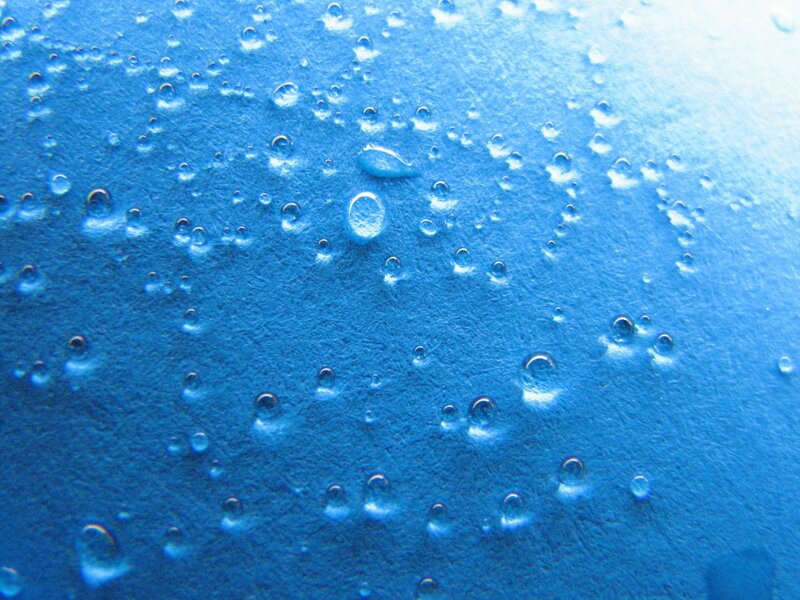 Water droplets on blue surface