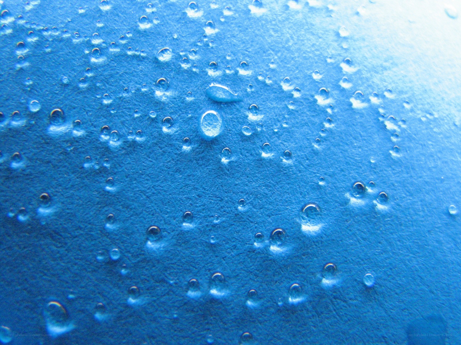 Water droplets on blue surface