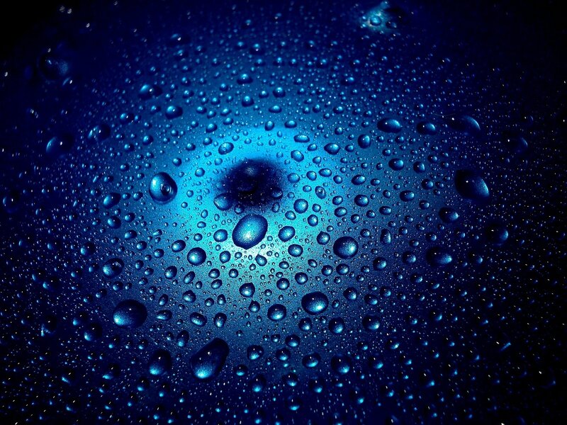 Water Droplets on Blue Surface — Dramatic, Photograph
