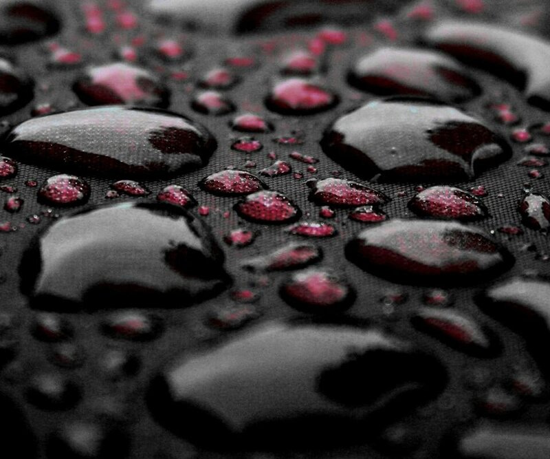 Water droplets on dark fabric