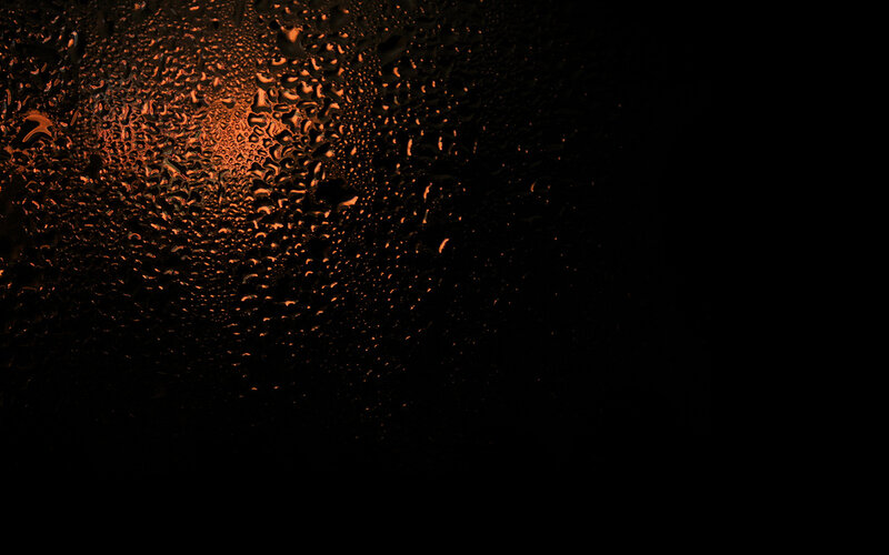 Water droplets on glass at night