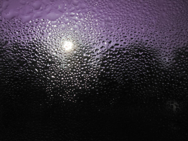 Water droplets on glass at night